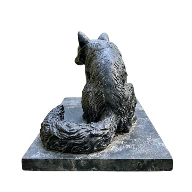 An impressive vintage cast iron fox statue.Meticulously crafted from solid cast iron, this piece features a heavy,...