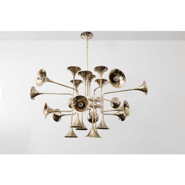 Beautiful 24-light handmade chandelier in golden brass with trumpet-shaped speakers, Botti Collection is a design line...