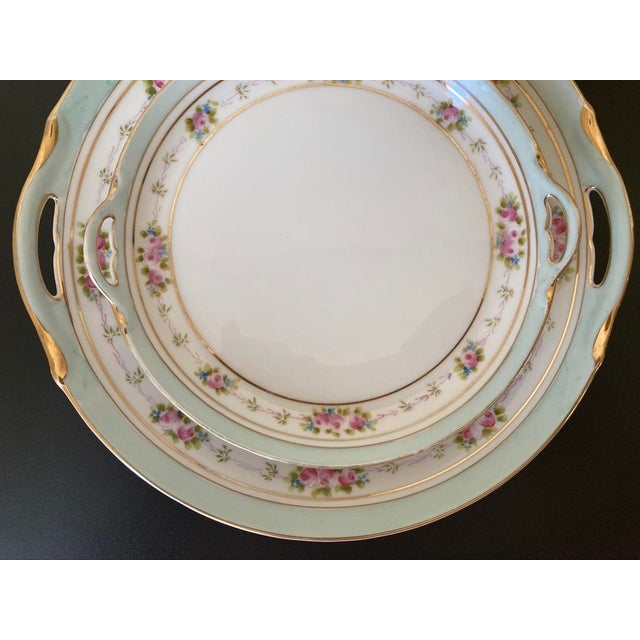 A beautiful set of two tray plates with roses and turquoise blue Nippon design, circa early 20th century, Japan. Handle...