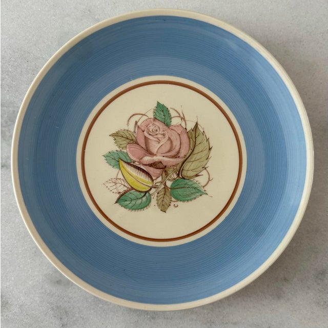 Set of 7 vintage Susie Cooper blue "Patricia Rose" small plates featuring a central pink rose design. Produced by Crown...