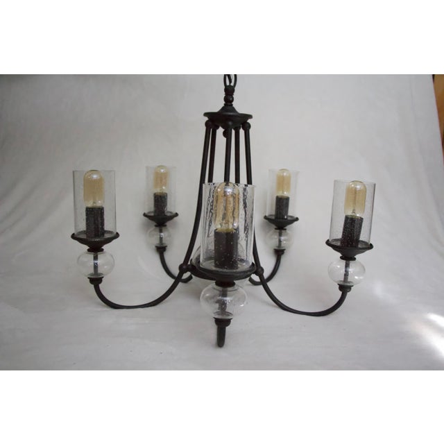This iron chandelier has been completely updated with beautiful bubble glass globes and Edison bulbs. The bulbs can be...