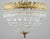Empire style semi flush mount ceiling light with basket shaped strands of cut crystals and an ornate brass frame and...