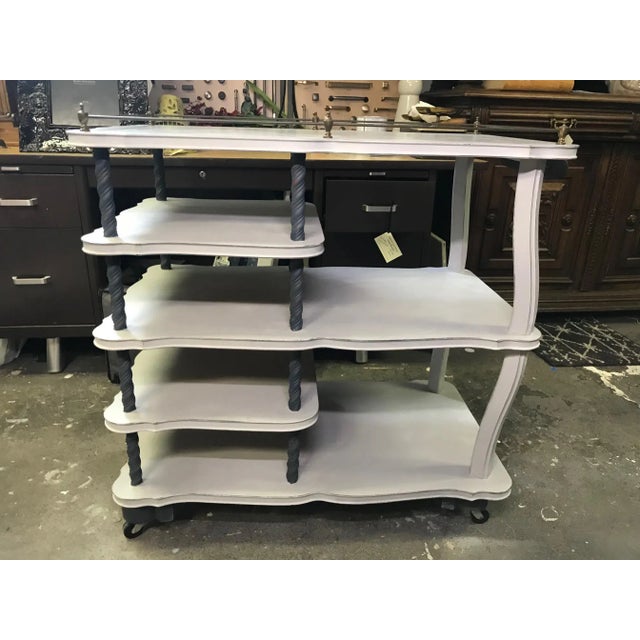 Vintage bar cart newly painted in a warm light grey with accents in dark navy (almost black). This wood cart has an...