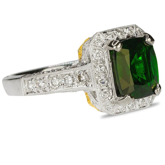 18k White gold ring set with 1 cushion cut chrome tourmaline weighing 1.83 carats and 0,74 carats of diamonds. 6.80 grams