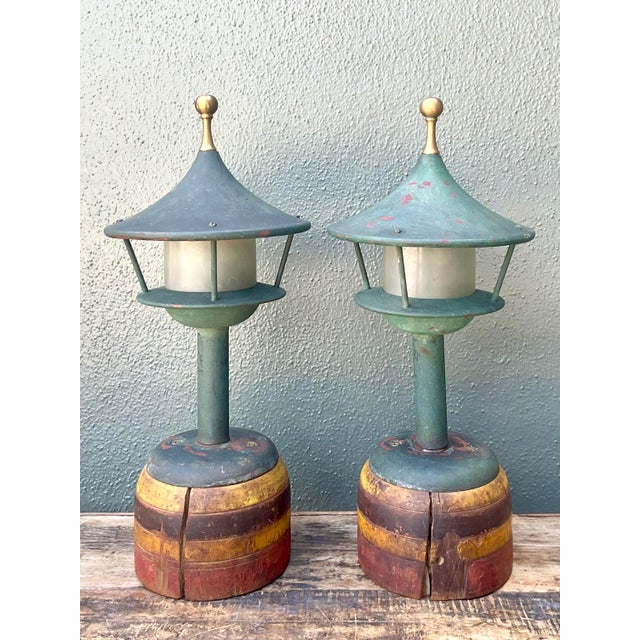 Capture the essence of mid-century coastal charm with this exceptional pair of patinated lighthouse lamps. Artfully...
