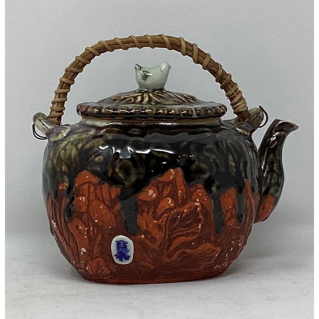 Sumida Gawa teapot. Vintage Japanese drip glaze over red ground. Figures on one side. Bird finial. Sumida Gawa art pottery...