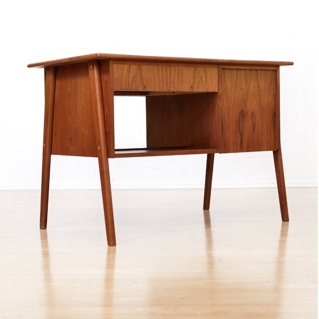 This Danish mid-century writing desk showcases the clean lines and refined craftsmanship that define Scandinavian modern...