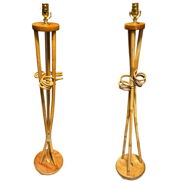 Restored set of Rattan lamps featuring a pair of Floor Lamps and with Matching Tabletop Lamp. Each lamp features an...