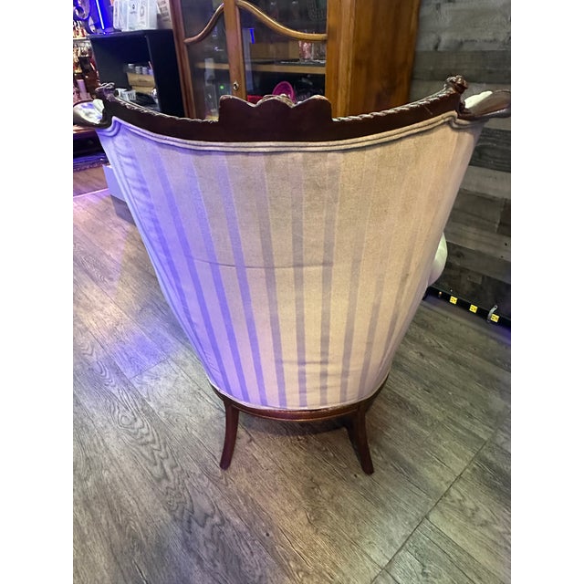 This is a Hollywood Regency Barrel Back chair from the early 20th century, it has mahogany accents. It measures 43" tall x...