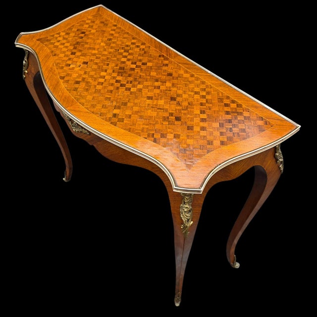 This 19th Century French Louis XV Revival Console Table with Fine Parquetry & Ormolu Mounts is a slight piece with...
