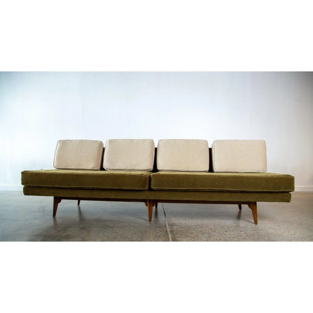 A 1950s iconic armless sofa designed by Edward Wormley for Dunbar Furniture model 5526. Reupholstered in a green mohair...