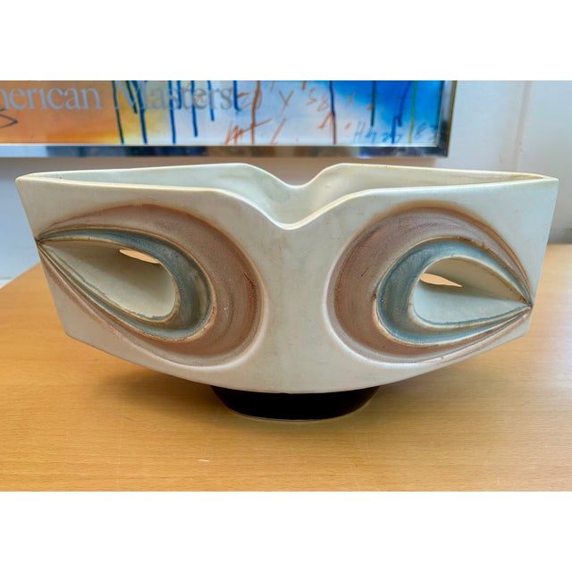 Beautiful carved off-white stoneware footed ikebana vase in light brown and blue wash and a black glazed foot. Signed on...