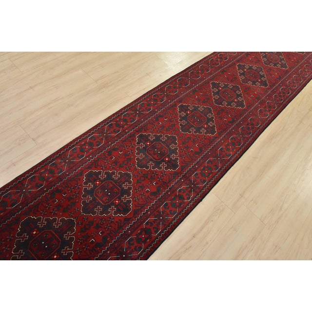 An authentic tribal Turkmen rug hand-knotted with fine wool and natural dyes. This nomadic rug features a row of geometric...