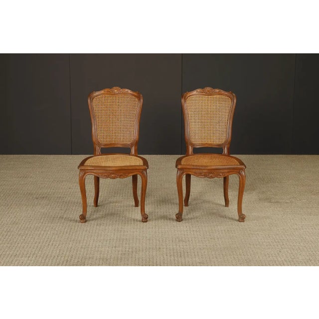 This charming pair of side chairs captures the quintessential elegance of the Louis XV style, with its sensuous curves,...