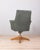 Swivel armchair with spring system, with wooden and iron base, green leather upholstery, design Anonima Castelli, 1950s....