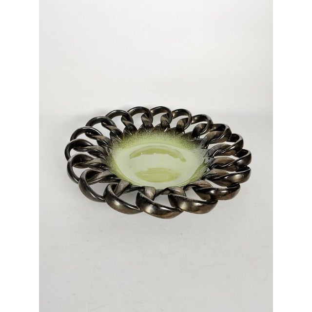 A black and yellow ceramic trinket tray, France, 1960s, with a bold and sculptural design. This piece is distinguished by...