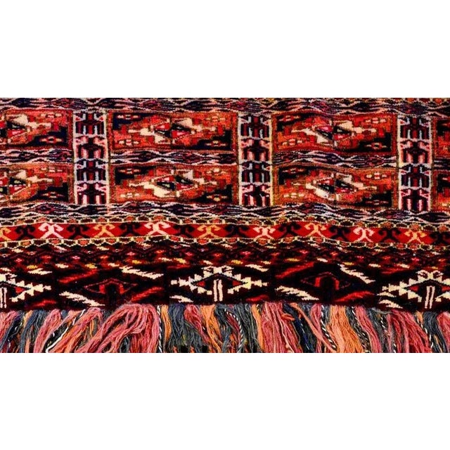 A wonderful early 20th century Persian Turkmen face rug with a densely woven geometric pattern woven in crimson and indigo...