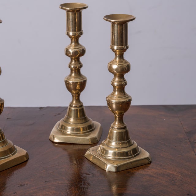 Three pairs of late Georgian, early Victorian brass push up candlesticks. tallest: 8 ¾ inches widest: 3 ½ inches
