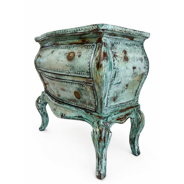 A beautifully hand-finished French Provincial bombé chest in a distressed Mediterranean green patina. The sculptural...