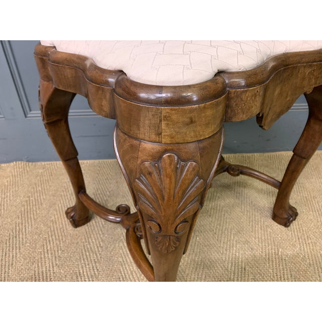 A charming burr walnut stool in the queen Anne style. Of excellent construction in solid walnut and attractive burr walnut...