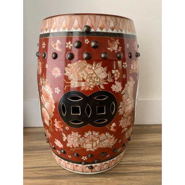 Beautifully detailed Chinese round garden seat or drinks table in elegant crimson. Black hobnails on top and bottom...