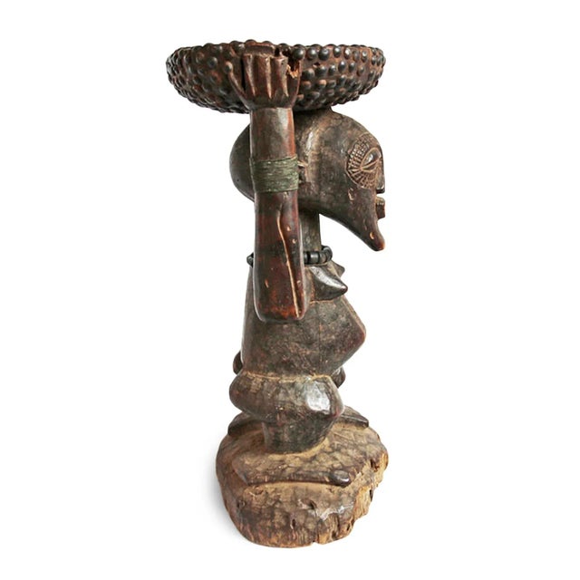 Important original antique Songye stool from central Congo. Used in ceremony this chief stool depicts a caryatid figure...