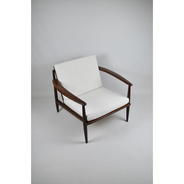 Armchair by designer Grete Jalk in solid teak, 1960s Refurbished cushions This piece is attributed to the mentioned...