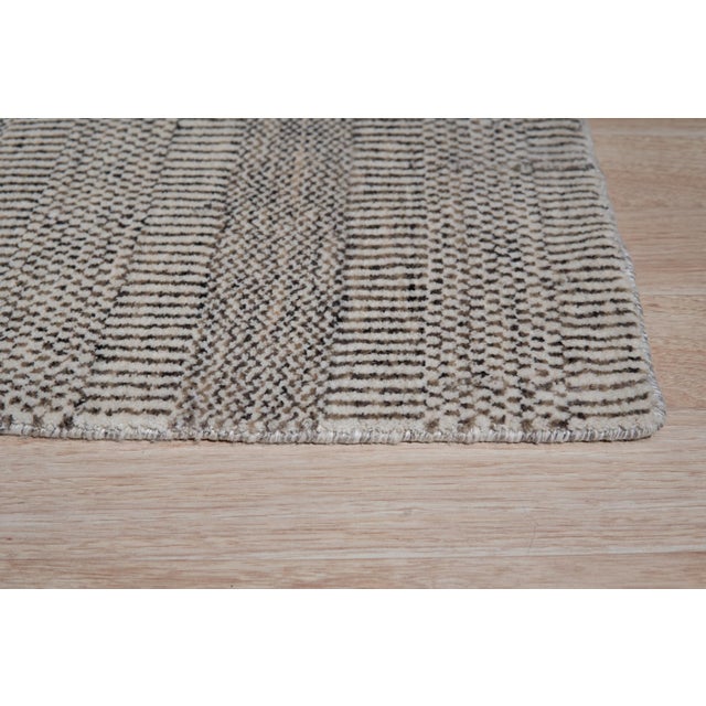 Trendy Dahlia Beige Handmade Wool Rug, Country of Origin: India. This piece showcases a sophisticated weaving tradition,...