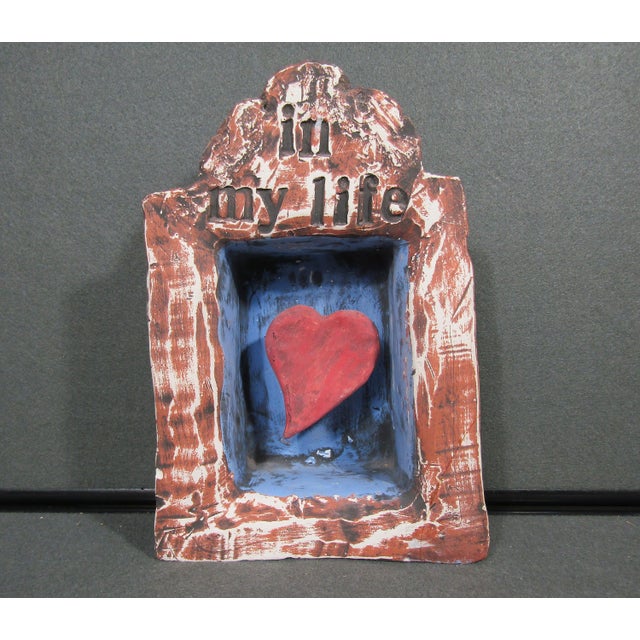A charming artist-signed folk art wall sculpture with a sweet romantic message, “in my life,” above a recessed blue...