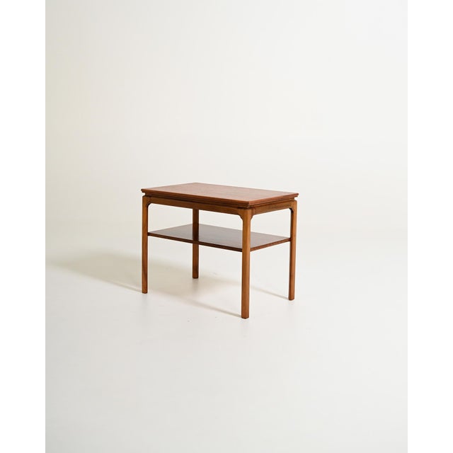 Rectangular coffee table with mahogany frame and lower shelf. Scandinavian production, 1950s-1960s. Dating to the 1950s or...