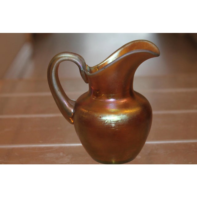 A beautiful petite sized authentic Steuben Glassworks Gold Aurene Liquid Pitcher - signed and Numbered. Frederic Carder...