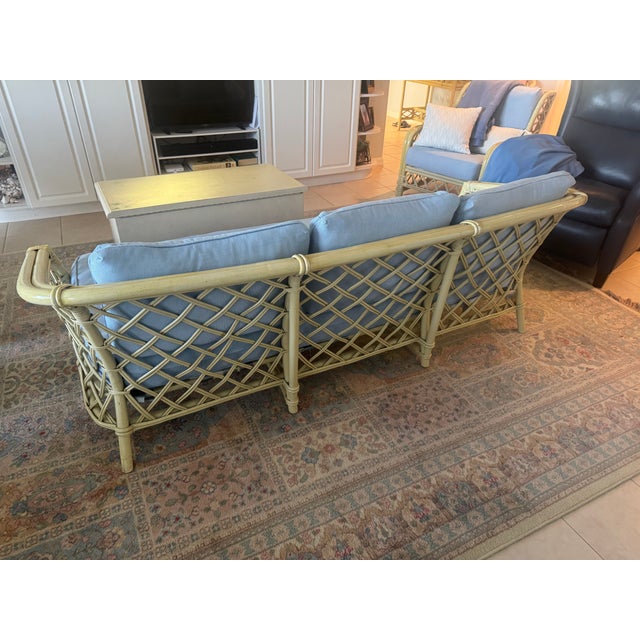 The piece was purchased in 1986. Ficks Reed distressed pineapple bamboo comes from a set. The arms were revarnished in...