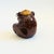A vintage ceramic ashtray in the shape of a bear wearing wire glasses. Features a large opening with a cigarette rest and...