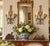 A beautifully detailed pair of Italian neoclassical wall sconces featuring a soft celadon green painted finish accented...
