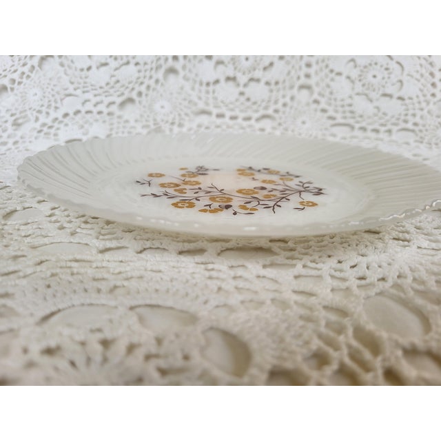 A milkglass floral plate, with goldenrod yellow blooms. This decorative plate has a hanger and is ready to display. It is...