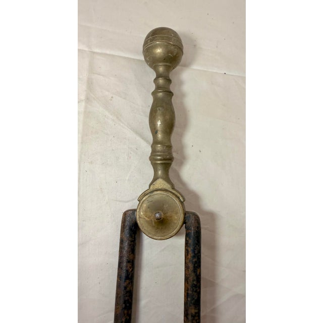 Up for sale is a nice pair of rare antique 18th century wrought iron and brass English fireplace tongs. The arms are...