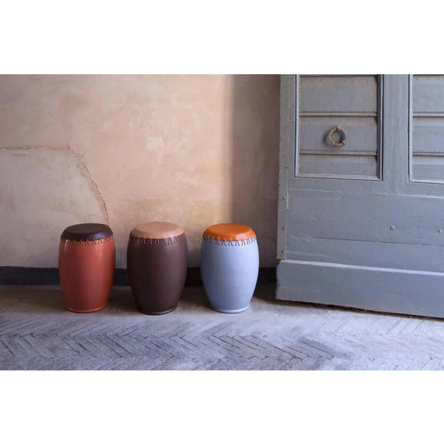 Bombo leather side tables by Nestor Perkal It can also be used as a stool Dimensions: 55 x 40 x 40 cm Enamelled stoneware...