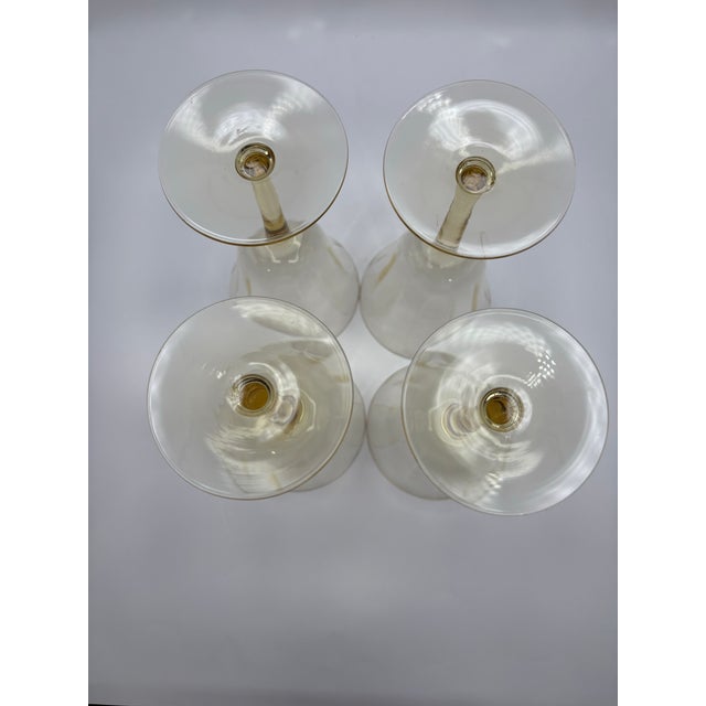 Delicate and light set of four yellow glass water goblets. Total height is 6 3/4” nicely proportional stem with bell shape...