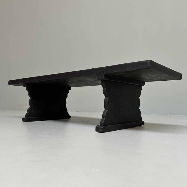 A simple Japanese writing desk resting on beautifully shaped supports. The minimalist design, the dark weathered wood, and...