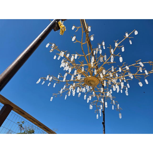 Beautiful contemporary style gold leaf branch design with chunks of uncut rock crystals hanging from the branches. A few...