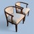 An elegant Mid-Century Modern pair of armchairs, crafted in rich teak and upholstered in a neutral boucle fabric. These...