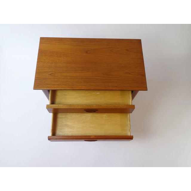 Amazing original Scandinavian set of nightstands made out of teak wood. The bedside tables have two drawers each and a...