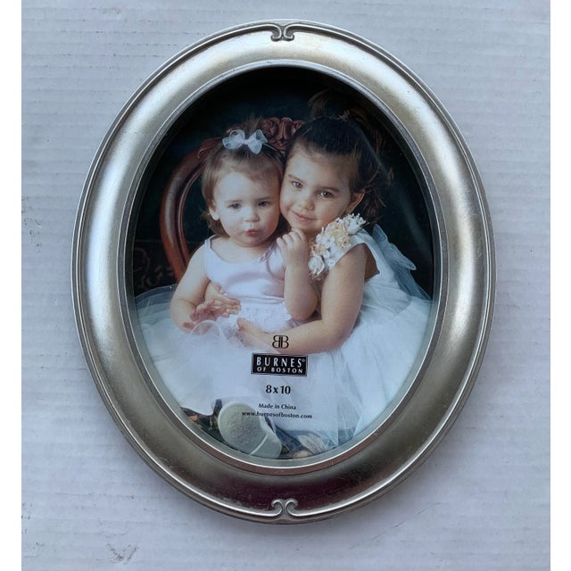 Very pretty silverleafed oval picture frame with easel back by Burnes of Boston. Will hold an 8 x 10 photo. Never used,...