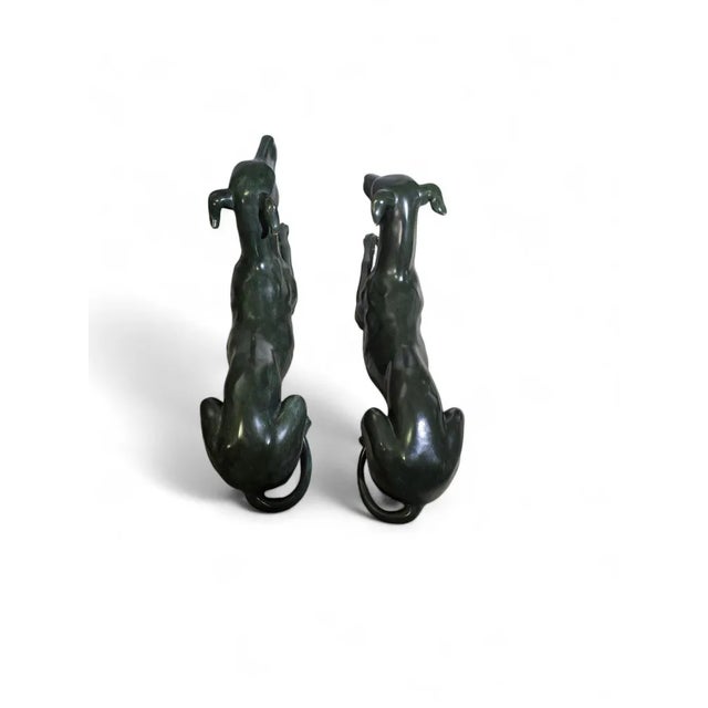 This sophisticated pair of Italian greyhound sculptures from the 1950s is crafted in green patinated bronze, showcasing...