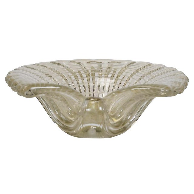 Vintage Italian handmade centerpiece vase is made of transparent/light yellow Murano glass with inlaid gold dust in the...