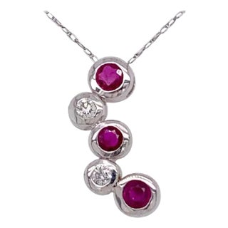 14kt Gold Ruby and Diamond Necklace Having 3 Rubies and 2 Round Diamonds For Sale