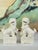 A lovely pair of vintage white ceramic Foo Dogs (Chinese Guardian Lions). Produced in the mid 20th century. Featuring a...