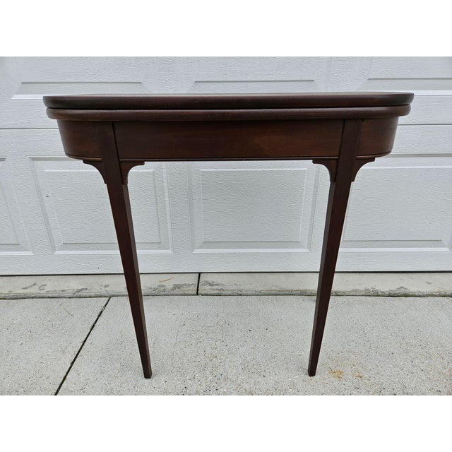 This is a simplistic yet elegant flip top mahogany console or game table. With the tabletop fully open and in place, the...