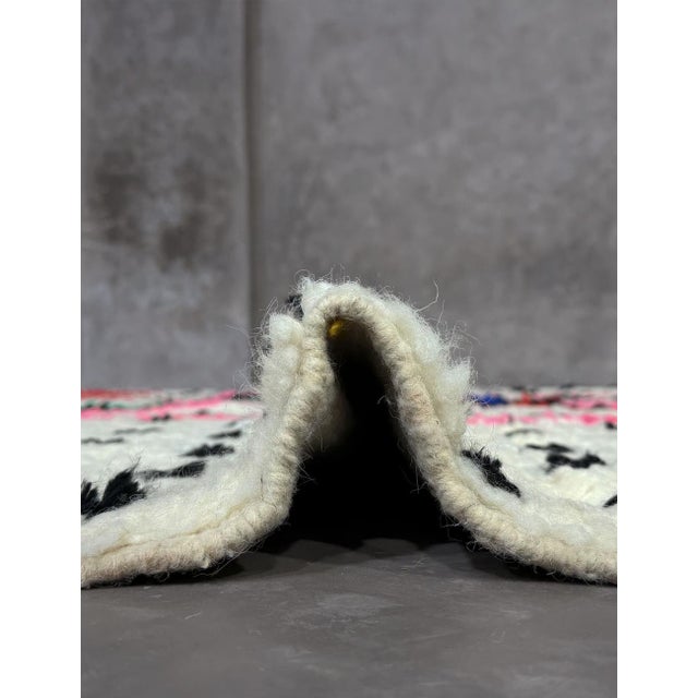 Handmade Azilal Wool Rug – Colorful Moroccan Berber Rug with Abstract Symbols This handmade Azilal wool rug beautifully...