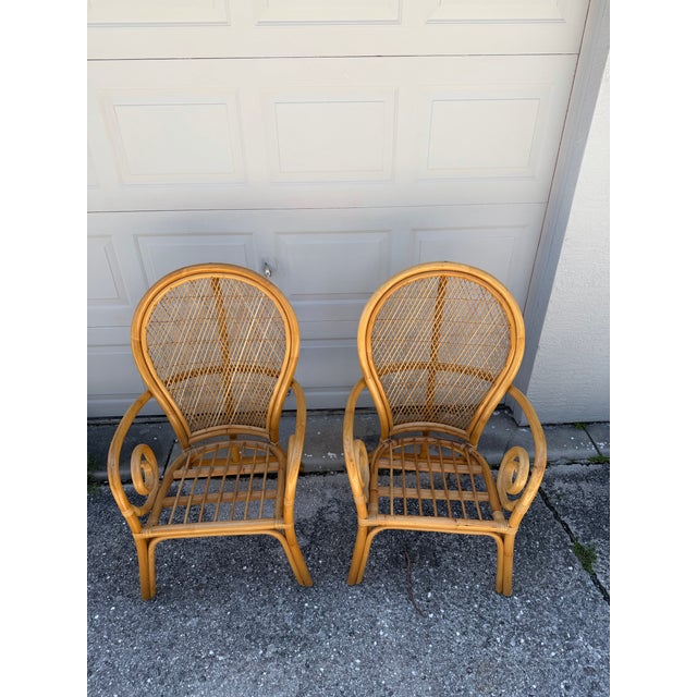 Striking pair of vintage bentwood rattan and wicker armchairs featuring tall, gracefully rounded woven backs and...